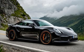 Картинка Porsche, 911 Turbo S, роскошный автомобиль, альпийский пейзаж, 4k, 1920х1080, драйв, чёрный автомобиль, облачный, горные виды, купе, извилистая дорога, премиальный сегмент, 2k, спорткар, природа, HD, скорость, приключения за рулём, нейросеть, облака, рабочий стол, элегантность, горные дороги, высокопроизводительный автомобиль, мощь, оранжевые акценты на дисках, спортивные диски, немецкий автопром, аэродинамический дизайн, пейзаж, ИИ, дорога в горах, зелень, скалы, 16:9, автомобильный дизайн