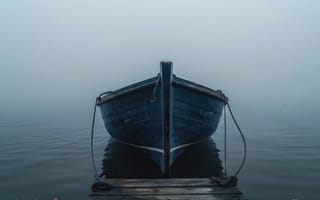 Картинка лодка, причал, утренний туман, тёмная лодка, верёвки, пасмурная погода, спокойная атмосфера, берег, одинокая лодка, тишина, деревянная лодка, деревянный причал, отражение в воде, туман, вода, умиротворение, природа, спокойная вода, морской пейзаж, морской туман