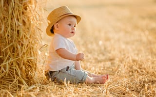 Картинка Маленький мальчик в шляпе сидит на себе
