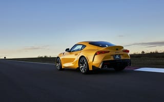 Картинка Желтый автомобиль Toyota GR Supra, 2021 года на трассе вид сзади