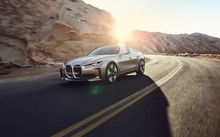 Картинка Автомобиль BMW Concept I4 2020 года у гор в лучах солнца