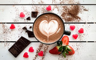 Картинка Чашка кофе с рисунком на пене на столе с шоколадом и клубникой