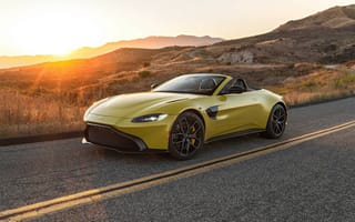 Картинка Желтый кабриолет Aston Martin Vantage Roadster, 2021 года на трассе на рассвете