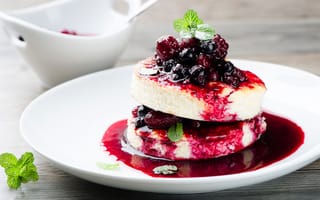 Картинка Аппетитные сырники с ягодами на белой тарелке