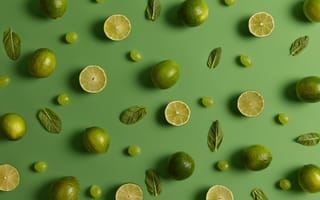 Картинка Лимоны и лаймы на зеленом фоне