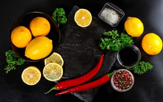 Картинка Лимоны на столе с красным перцем, петрушкой и специями